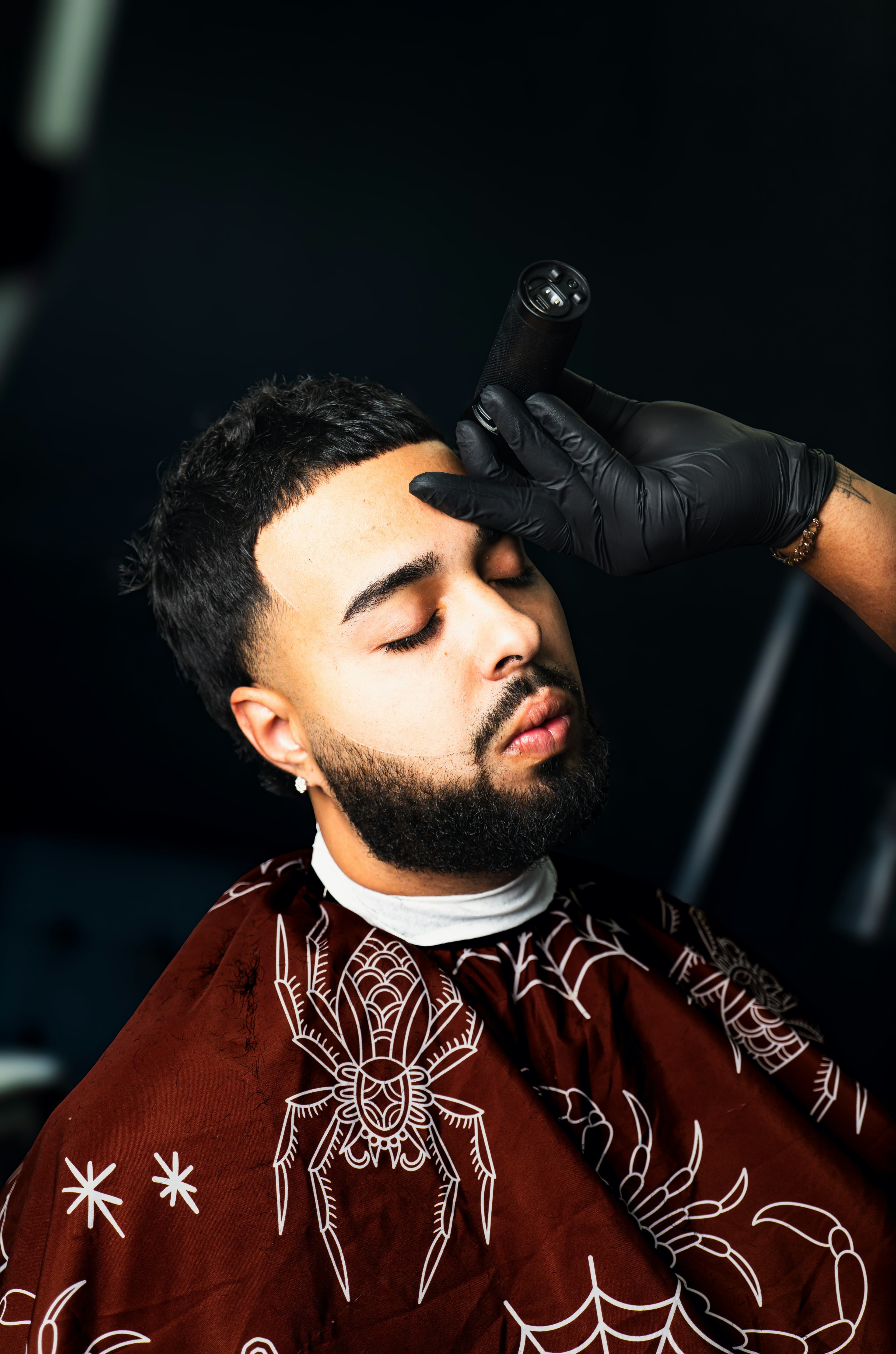 Barber shaping a client's hairline